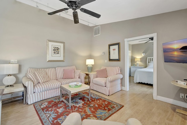 2940 SE Treasure Island Rd, Port Saint Lucie, FL 34952 - living room with light wood finished floors, a ceiling fan, and visible vents