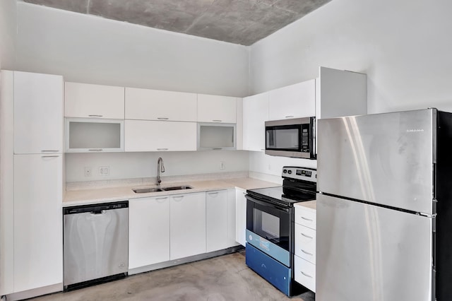 234 NE 3rd St Unit 2206, Miami, FL 33132 - kitchen featuring appliances with stainless steel finishes, finished concrete floors, white cabinetry, light countertops, and modern cabinets