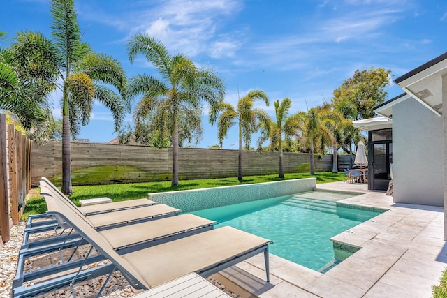 view of swimming pool with a patio area, a fenced in pool, and a fenced backyard