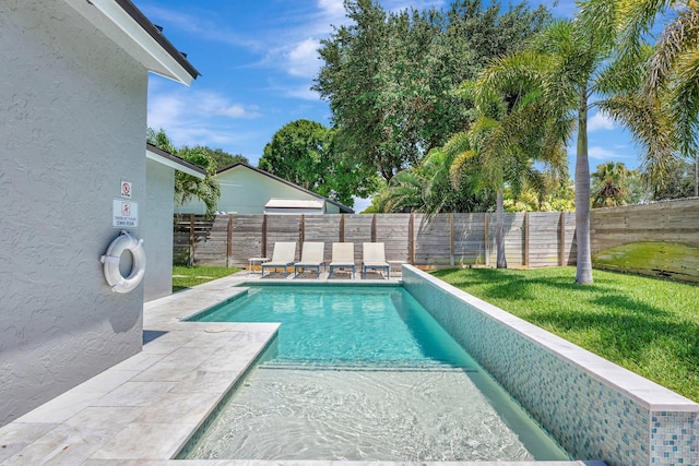view of swimming pool featuring a fenced backyard, a patio area, a fenced in pool, and a lawn
