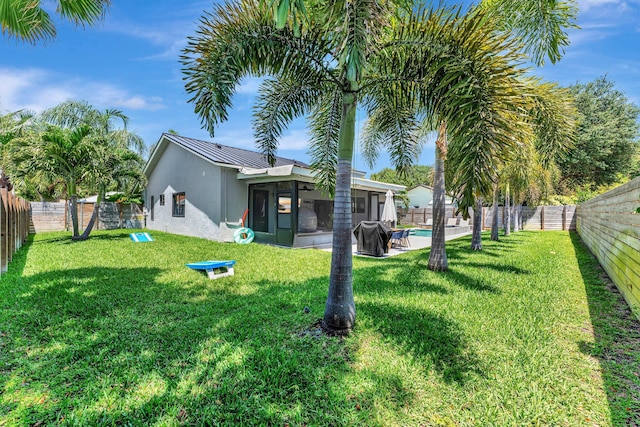 view of yard with a sunroom, a fenced in pool, and a fenced backyard
