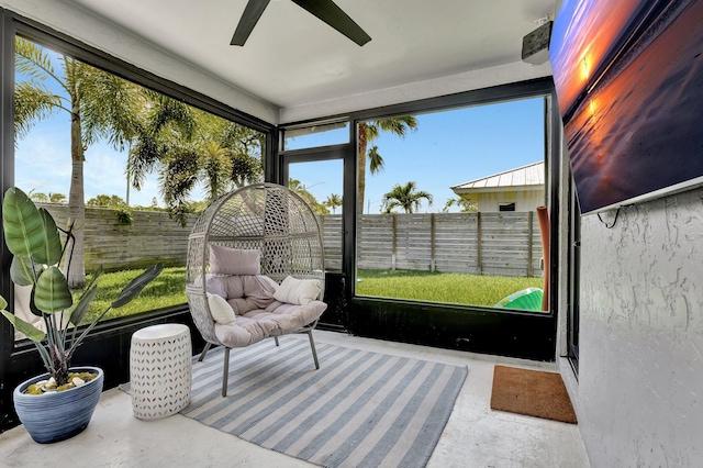 sunroom / solarium featuring ceiling fan