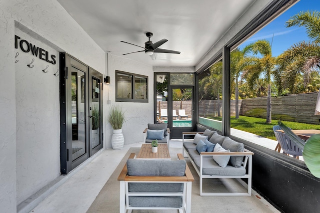 sunroom / solarium with a ceiling fan and an outdoor living space