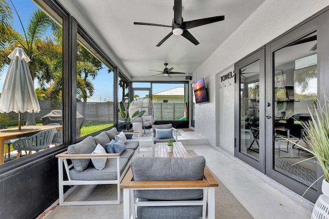 sunroom with an outdoor living space, french doors, a ceiling fan, and plenty of natural light