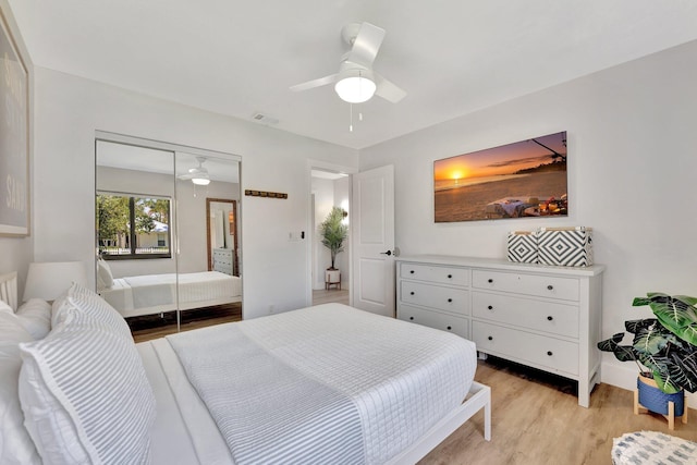 bedroom with a closet, visible vents, ceiling fan, baseboards, and light wood-style floors