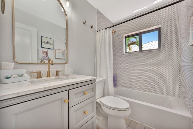 bathroom featuring toilet, shower / tub combo with curtain, and vanity