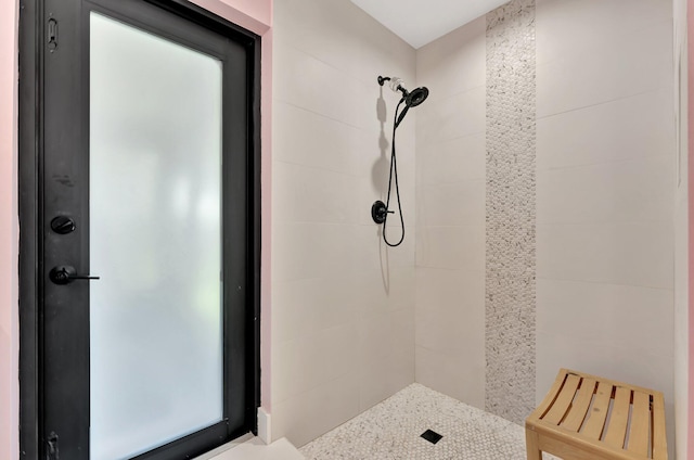 bathroom with a tile shower
