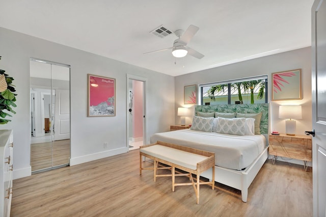 bedroom featuring light wood-type flooring, visible vents, baseboards, and a ceiling fan