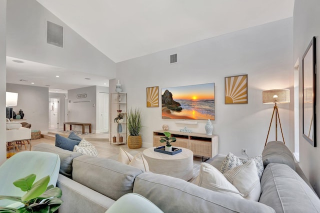 living area featuring recessed lighting, light wood-style floors, visible vents, and high vaulted ceiling