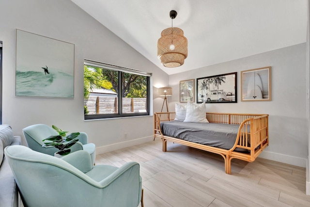 bedroom featuring wood finished floors, vaulted ceiling, and baseboards