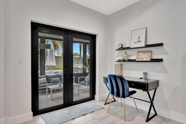 home office featuring baseboards, french doors, and wood finished floors