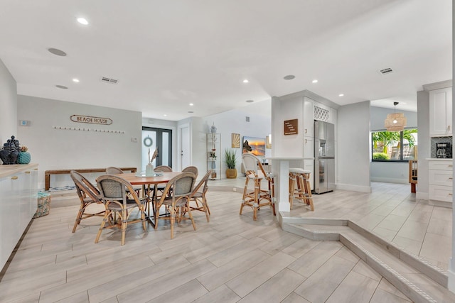 dining room with baseboards, visible vents, wood tiled floor, and recessed lighting