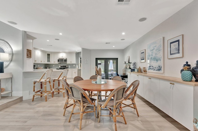 dining space featuring french doors, visible vents, and recessed lighting