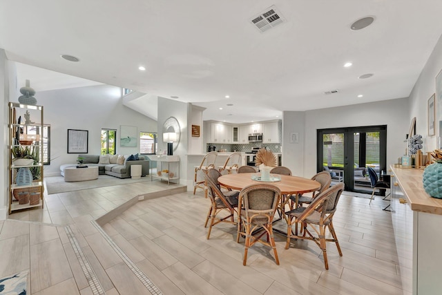 dining space with a healthy amount of sunlight, french doors, visible vents, and recessed lighting