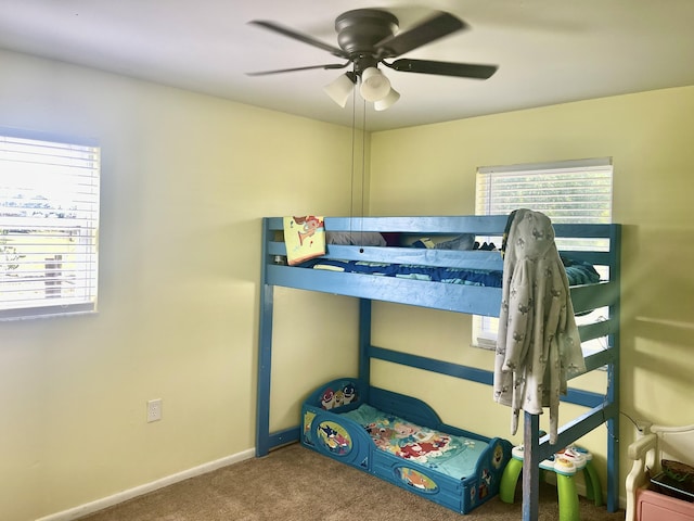 7677 NW 90th Ct, Okeechobee, FL 34972 - bedroom with carpet flooring, multiple windows, a ceiling fan, and baseboards