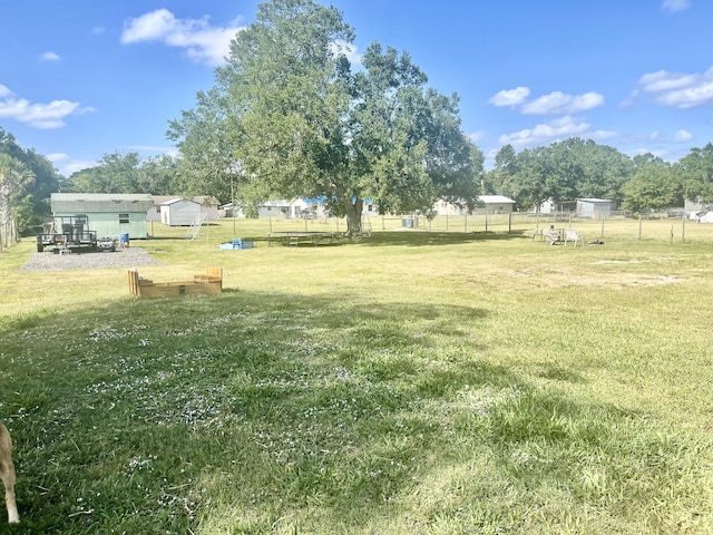 7677 NW 90th Ct, Okeechobee, FL 34972 - view of yard featuring an outbuilding and a vegetable garden