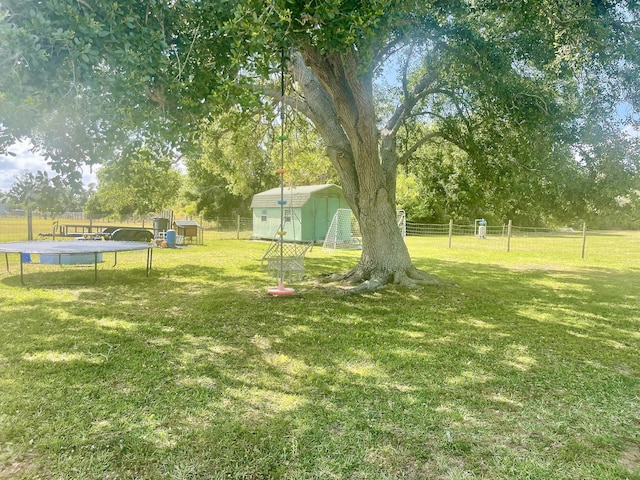 7677 NW 90th Ct, Okeechobee, FL 34972 - view of yard featuring view of wooded area and a trampoline