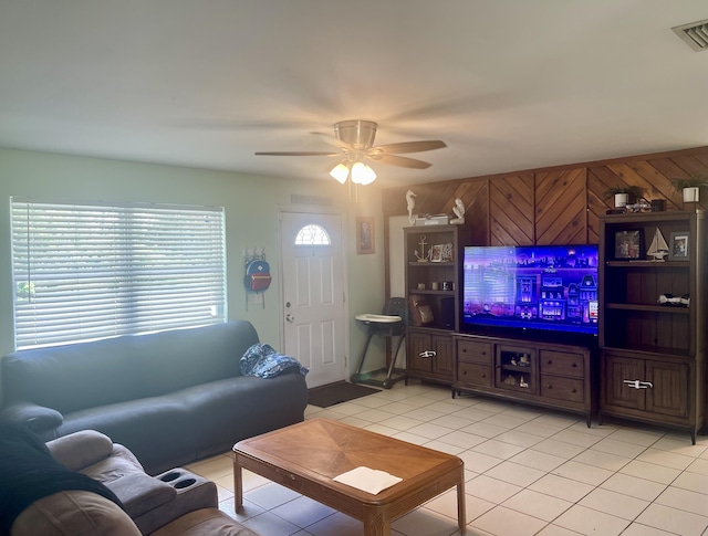 7677 NW 90th Ct, Okeechobee, FL 34972 - living area with light tile patterned flooring, a ceiling fan, and wood walls