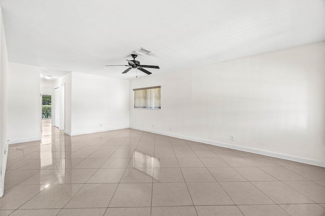 spare room with visible vents, a ceiling fan, tile patterned floors, and a wealth of natural light