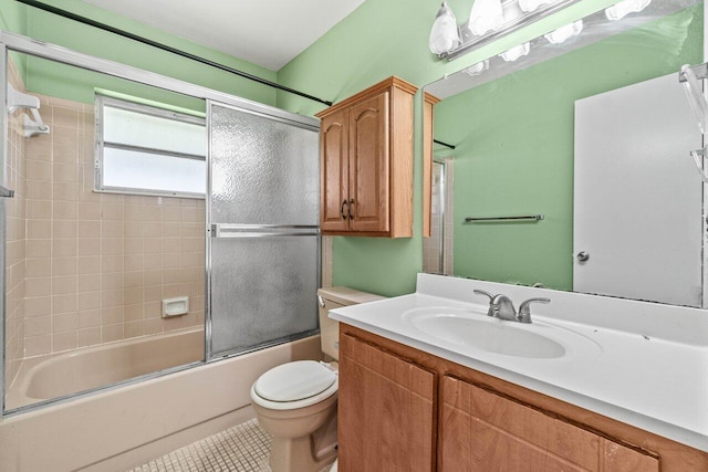 full bath with vanity, toilet, tile patterned flooring, and bath / shower combo with glass door