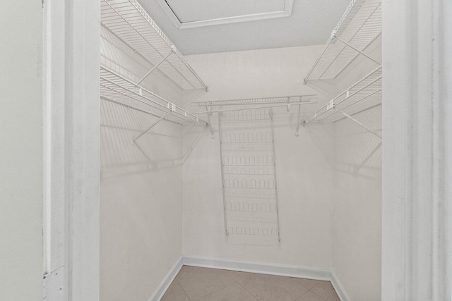 walk in closet featuring tile patterned flooring