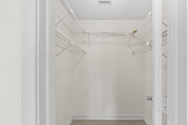 walk in closet featuring tile patterned floors