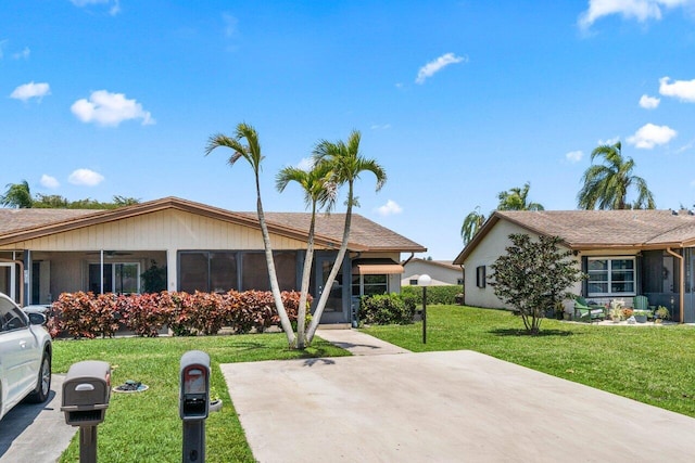 single story home with a ceiling fan and a front yard