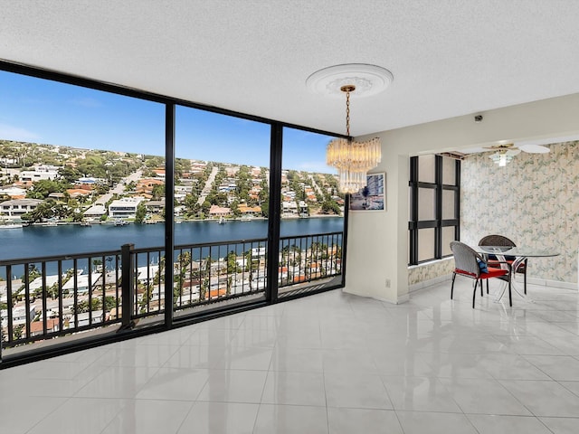 4740 S Ocean Blvd Unit 606, Highland Beach, FL 33487 - empty room with a water view, a textured ceiling, floor to ceiling windows, and baseboards