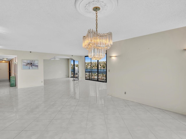 4740 S Ocean Blvd Unit 606, Highland Beach, FL 33487 - empty room featuring a notable chandelier and light tile patterned floors