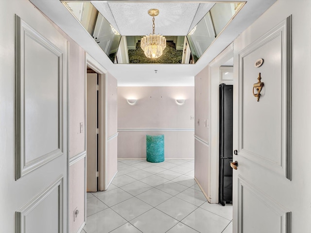 4740 S Ocean Blvd Unit 606, Highland Beach, FL 33487 - corridor featuring light tile patterned floors and a chandelier