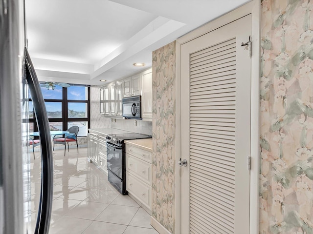 4740 S Ocean Blvd Unit 606, Highland Beach, FL 33487 - kitchen featuring ceiling fan, light tile patterned floors, light countertops, black appliances, and recessed lighting