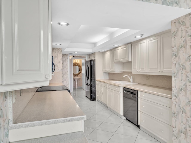 4740 S Ocean Blvd Unit 606, Highland Beach, FL 33487 - kitchen featuring a sink, light countertops, black appliances, and a tray ceiling