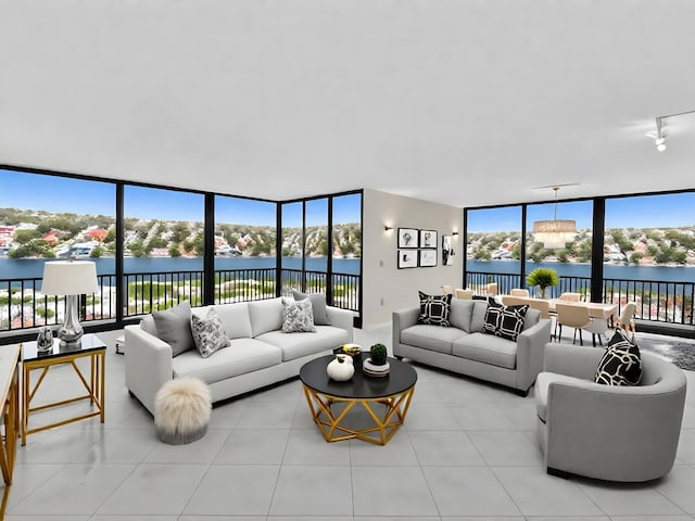 4740 S Ocean Blvd Unit 606, Highland Beach, FL 33487 - living area featuring a wall of windows, a water view, and light tile patterned flooring