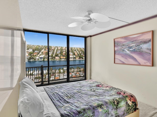 4740 S Ocean Blvd Unit 606, Highland Beach, FL 33487 - carpeted bedroom featuring ceiling fan, a water view, access to outside, and a textured ceiling
