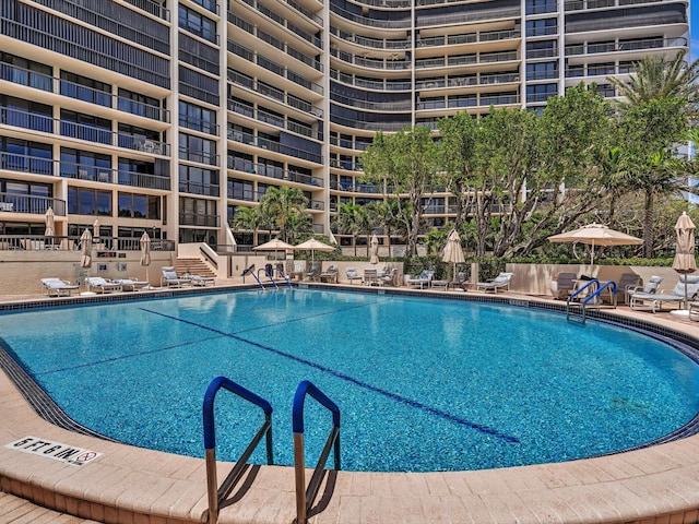 4740 S Ocean Blvd Unit 606, Highland Beach, FL 33487 - community pool featuring a patio and fence