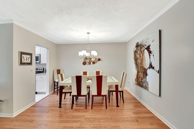 14699 Canalview C Dr Unit C, Delray Beach, FL 33484 - dining room featuring a textured ceiling, ornamental molding, light wood-type flooring, a chandelier, and baseboards