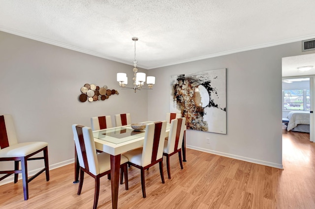 14699 Canalview C Dr Unit C, Delray Beach, FL 33484 - dining area featuring light wood finished floors, a textured ceiling, a chandelier, ornamental molding, and baseboards