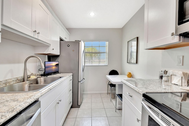 14699 Canalview C Dr Unit C, Delray Beach, FL 33484 - kitchen featuring stainless steel appliances, a sink, white cabinetry, baseboards, and light tile patterned floors