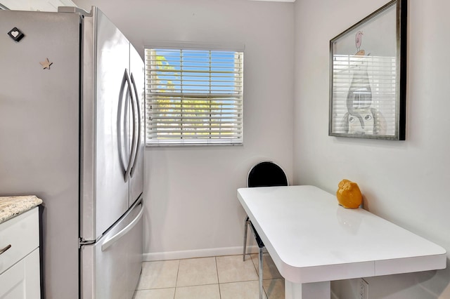 14699 Canalview C Dr Unit C, Delray Beach, FL 33484 - kitchen with freestanding refrigerator, light countertops, white cabinetry, light tile patterned flooring, and baseboards