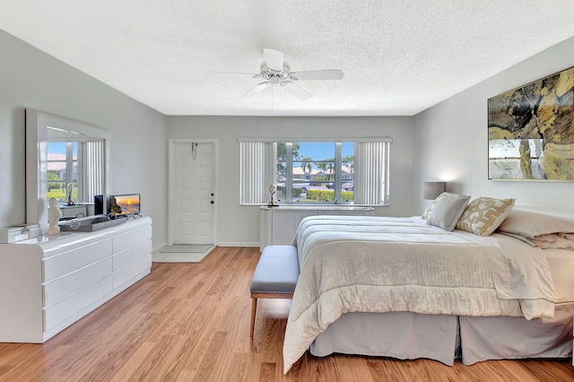14699 Canalview C Dr Unit C, Delray Beach, FL 33484 - bedroom featuring multiple windows, light wood-type flooring, ceiling fan, and a textured ceiling
