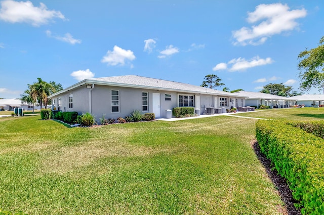14699 Canalview C Dr Unit C, Delray Beach, FL 33484 - back of property with stucco siding and a lawn