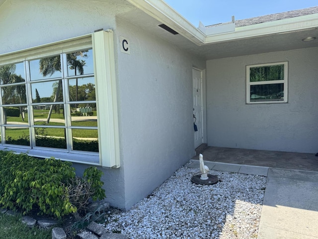 14699 Canalview C Dr Unit C, Delray Beach, FL 33484 - view of exterior entry featuring stucco siding
