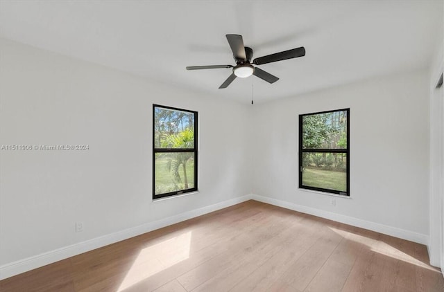 15763 Alexander Run, Jupiter, FL 33478 - unfurnished room with wood finished floors, baseboards, and ceiling fan