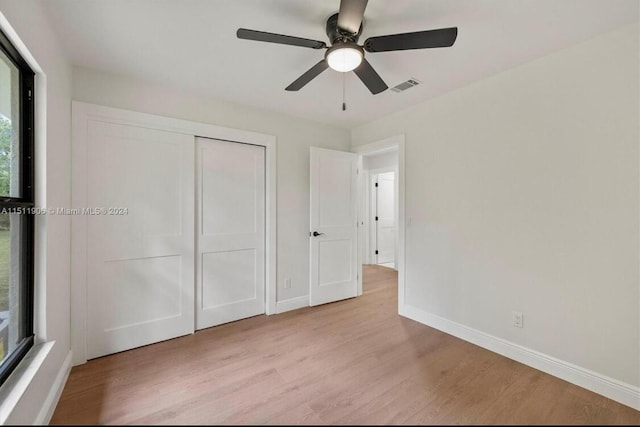 15763 Alexander Run, Jupiter, FL 33478 - unfurnished bedroom featuring wood finished floors, baseboards, a closet, and a ceiling fan