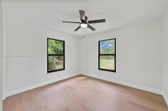 15763 Alexander Run, Jupiter, FL 33478 - empty room with plenty of natural light, wood finished floors, baseboards, and ceiling fan