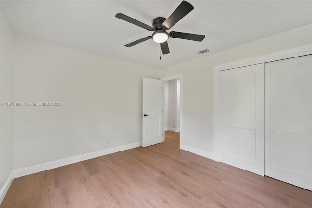 15763 Alexander Run, Jupiter, FL 33478 - unfurnished bedroom featuring light wood-style flooring, baseboards, a closet, and a ceiling fan