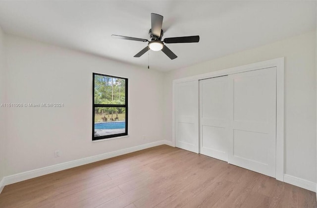 15763 Alexander Run, Jupiter, FL 33478 - unfurnished bedroom with light wood finished floors, baseboards, a closet, and ceiling fan