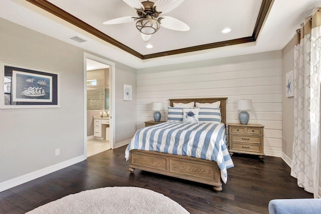 420 SE Bancroft Ct, Port Saint Lucie, FL 34984 - bedroom with ornamental molding, wood finished floors, baseboards, a tray ceiling, and connected bathroom