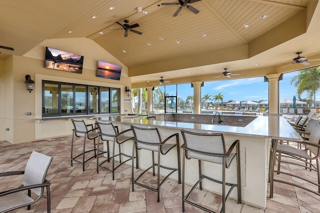 view of patio featuring outdoor wet bar and a ceiling fan