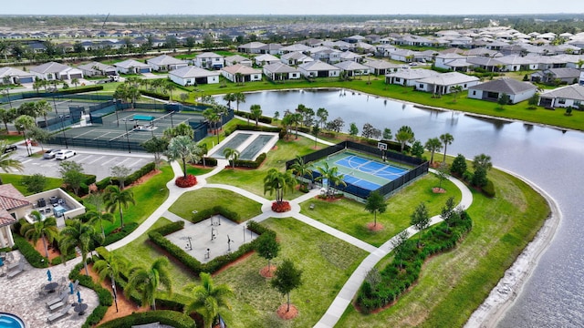 drone / aerial view featuring a residential view and a water view